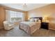 Warm bedroom featuring plush carpet, a decorative chandelier and furniture at 7141 Red Mesa Dr, Littleton, CO 80125