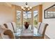 Bright dining room features a glass table, natural light, and beautiful views at 7141 Red Mesa Dr, Littleton, CO 80125
