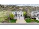 Two-story home featuring a double garage, covered porch, and views of a rocky hillside in the background at 7141 Red Mesa Dr, Littleton, CO 80125