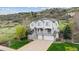 Charming two-story home with a welcoming front porch and three-car garage at 7141 Red Mesa Dr, Littleton, CO 80125