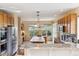 Bright kitchen with oak cabinets, granite counters and stainless steel appliances at 7141 Red Mesa Dr, Littleton, CO 80125
