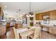 Eat-in kitchen features a long table, desk area and oak cabinets at 7141 Red Mesa Dr, Littleton, CO 80125