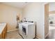 Laundry room area with front load washer and dryer and adjacent countertop at 7141 Red Mesa Dr, Littleton, CO 80125