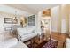 Open concept living area showcases hardwood floors, access to the dining area, and great natural light at 7141 Red Mesa Dr, Littleton, CO 80125