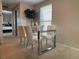 Modern dining area featuring glass table and white chairs at 1496 S Pierson St # 116, Denver, CO 80232