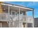 Exterior view of the gray apartment complex with unit number 1496, porch with white fence at 1496 S Pierson St # 116, Denver, CO 80232