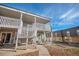 Exterior view of condo with private balcony and a well-maintained landscaped courtyard at 1496 S Pierson St # 116, Denver, CO 80232
