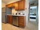 Kitchen boasts stainless steel dishwasher and wood cabinets at 1496 S Pierson St # 116, Denver, CO 80232
