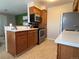 Kitchen with wood cabinets, stainless steel appliances and flooring at 1496 S Pierson St # 116, Denver, CO 80232