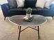 Cozy living room featuring a black sofa, accent pillows, and a modern coffee table with decor at 1496 S Pierson St # 116, Denver, CO 80232