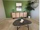 Living room with green accent wall and modern decor at 1496 S Pierson St # 116, Denver, CO 80232