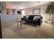 Living area features a black leather couch and modern coffee table at 1496 S Pierson St # 116, Denver, CO 80232