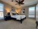 Main bedroom with king bed, artwork, and window coverings at 1496 S Pierson St # 116, Denver, CO 80232