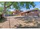 Spacious backyard with large tree and partial view of neighboring property at 1104 Elmer Dr, Northglenn, CO 80233