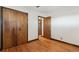 Bedroom with hardwood floors and double door closet at 1104 Elmer Dr, Northglenn, CO 80233