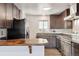 Modern kitchen with stainless steel appliances and wood countertops at 1104 Elmer Dr, Northglenn, CO 80233