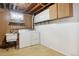 Basement laundry room with washer, dryer, and shelving at 1104 Elmer Dr, Northglenn, CO 80233