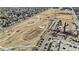 Aerial view of the neighborhood with a park, parking lots, and community buildings at 1973 Alton St, Aurora, CO 80010