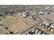 Neighborhood aerial view showing houses close to community park, school, and commercial zone at 1973 Alton St, Aurora, CO 80010