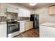 Kitchen with stainless steel appliances, natural wood cabinets, and new backsplash at 1973 Alton St, Aurora, CO 80010