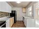 Kitchen with stainless steel appliances, natural wood cabinets, and new backsplash at 1973 Alton St, Aurora, CO 80010