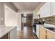 Kitchen with stainless steel appliances and natural wood cabinets and new backsplash at 1973 Alton St, Aurora, CO 80010