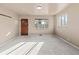 Bright living room featuring fresh neutral paint, large window and carpet at 1973 Alton St, Aurora, CO 80010