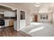 Open concept living and dining room featuring hardwood floors and fresh paint at 1973 Alton St, Aurora, CO 80010