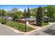 An aerial shot showcasing a well-kept lawn, single-car garage, extended driveway, and brick exterior at 6025 Johnson Way, Arvada, CO 80004