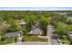 Bird's-eye view of a home with a well-manicured lawn, detached garage, and mature trees in a quiet neighborhood at 6025 Johnson Way, Arvada, CO 80004