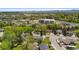 Scenic aerial view captures a suburban neighborhood with tree-lined streets, nearby shops, and community amenities at 6025 Johnson Way, Arvada, CO 80004