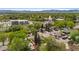 Expansive aerial view showcases a residential neighborhood with tree-lined streets and community amenities at 6025 Johnson Way, Arvada, CO 80004