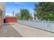 A concrete backyard featuring privacy fence and storage shed at 6025 Johnson Way, Arvada, CO 80004