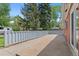 A spacious backyard featuring a long concrete patio and partial fencing at 6025 Johnson Way, Arvada, CO 80004