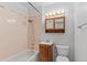 Small bathroom features a shower/tub combo and wooden vanity at 6025 Johnson Way, Arvada, CO 80004