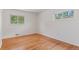 Empty bedroom features bright hardwood floors, and two windows at 6025 Johnson Way, Arvada, CO 80004