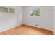 Empty bedroom with hardwood floors and two windows at 6025 Johnson Way, Arvada, CO 80004