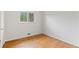 An empty bedroom boasts hardwood flooring and bright natural light at 6025 Johnson Way, Arvada, CO 80004