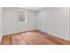 A cozy bedroom featuring wood-look flooring and natural light from a window at 6025 Johnson Way, Arvada, CO 80004
