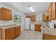 Well-lit kitchen with tiled floors, oak cabinets, modern appliances, and generous counter space for cooking at 6025 Johnson Way, Arvada, CO 80004