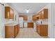 Spacious kitchen featuring tiled floors, oak cabinets, and modern appliances, offering functionality and style at 6025 Johnson Way, Arvada, CO 80004
