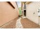 Narrow backyard featuring a rock drain, mulch, and building exteriors on each side at 2940 Ulster St, Denver, CO 80238
