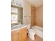 Cozy bathroom with a vanity, toilet, and shower-tub combination with neutral tiling at 2940 Ulster St, Denver, CO 80238