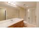 Bright bathroom with light countertops, wooden cabinets, and a glass-enclosed shower at 2940 Ulster St, Denver, CO 80238