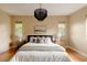 Comfortable bedroom with decorative chandelier, plush bedding, and side tables at 2940 Ulster St, Denver, CO 80238