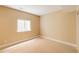 Neutral bedroom featuring carpet flooring, a window, and light colored walls at 2940 Ulster St, Denver, CO 80238