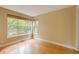 Bright bedroom featuring light hardwood floors, neutral walls, and natural light from multiple windows at 2940 Ulster St, Denver, CO 80238