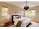 Bright bedroom with a decorative chandelier, plush bedding, and side tables at 2940 Ulster St, Denver, CO 80238