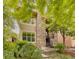 Charming two-story home with a stone facade and a beautifully landscaped front yard at 2940 Ulster St, Denver, CO 80238