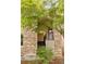 Charming home exterior featuring a stone facade and covered porch with black metal railings at 2940 Ulster St, Denver, CO 80238